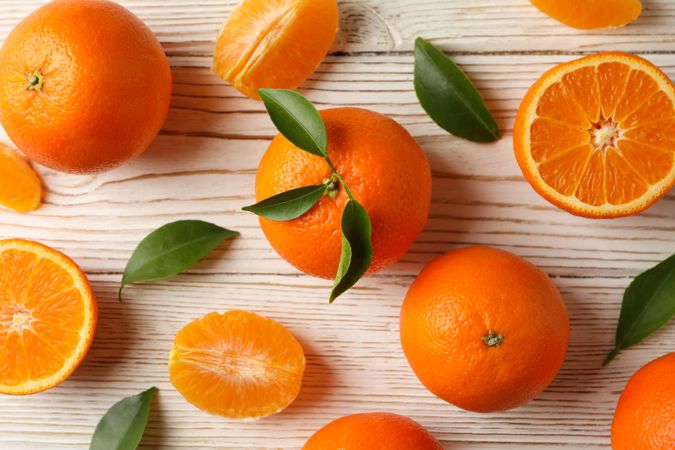 Ripe sweet mandarins on wooden background, top view