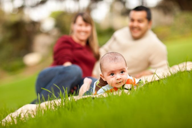 Happy Baby Boy and Parents Playing in the Park