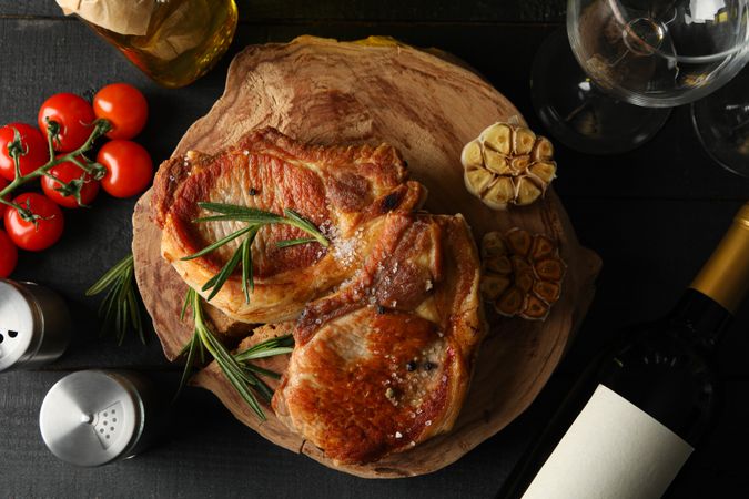 Composition with fried steaks and wine. Grilled food