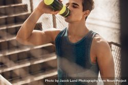 Muscular young man drinking water after workout 4Baq9k