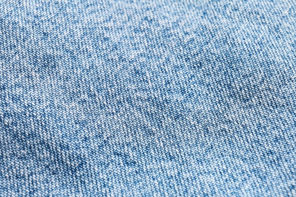 Texture of blue jeans as background, space for text
