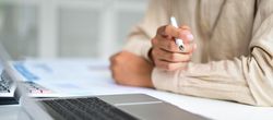 Male hands on desk with laptop