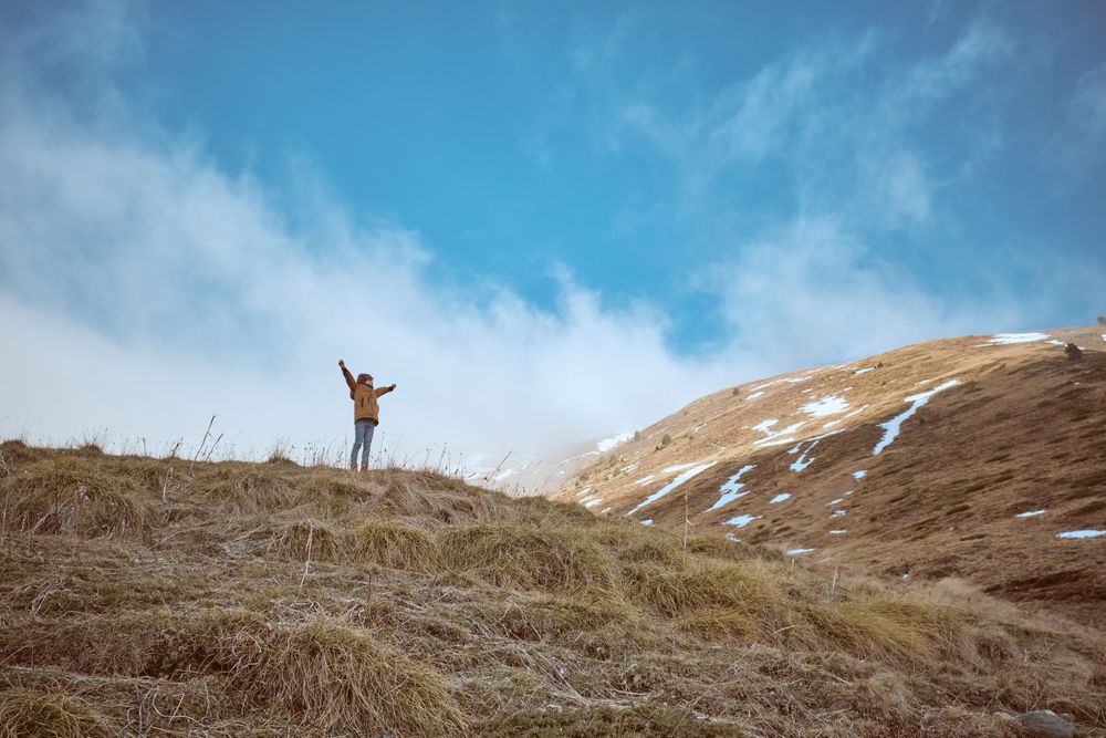 Anonymous boy on grassy hill