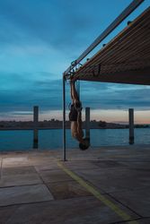 Athletic man balancing on gymnastic rings