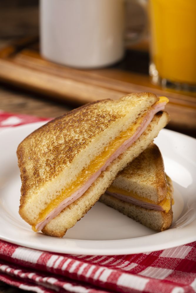 Grilled ham and cheese. Sandwich with cheese and ham on grill.