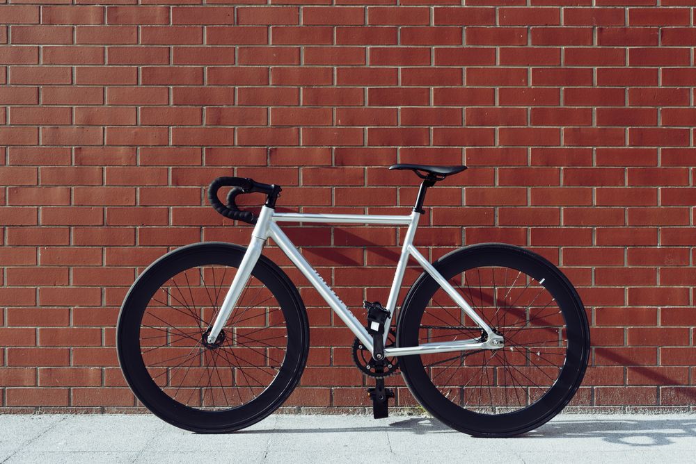 Road bicycle against brick wall