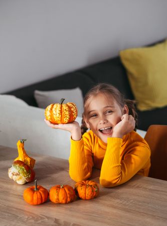 Little Girl Playing With a Pumpkin.