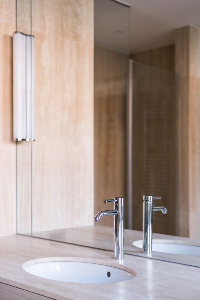 Sink with wooden counter in stylish bathroom