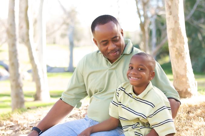 Man and Child Having Fun At The Park