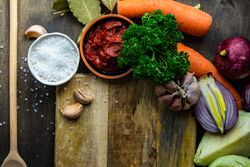 Tomato paste with carrot, bay leaf & onion ready for food prep