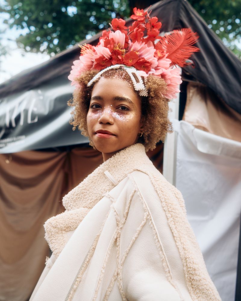 London, England, United Kingdom - August 28, 2022: Woman with glitter on her face & flowers in hair