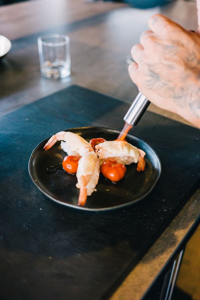 Chef blow torching prawn