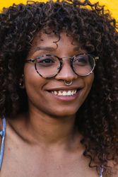 Trendy female against bright yellow wall