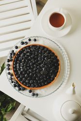 Concept of tasty breakfast with blueberry pie on table