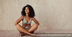 Cheerful young female model embracing her natural body 0JQLnb
