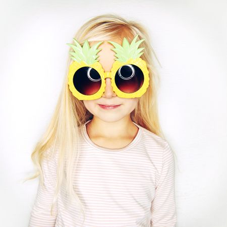 Blonde girl wearing big pineapple sunglasses