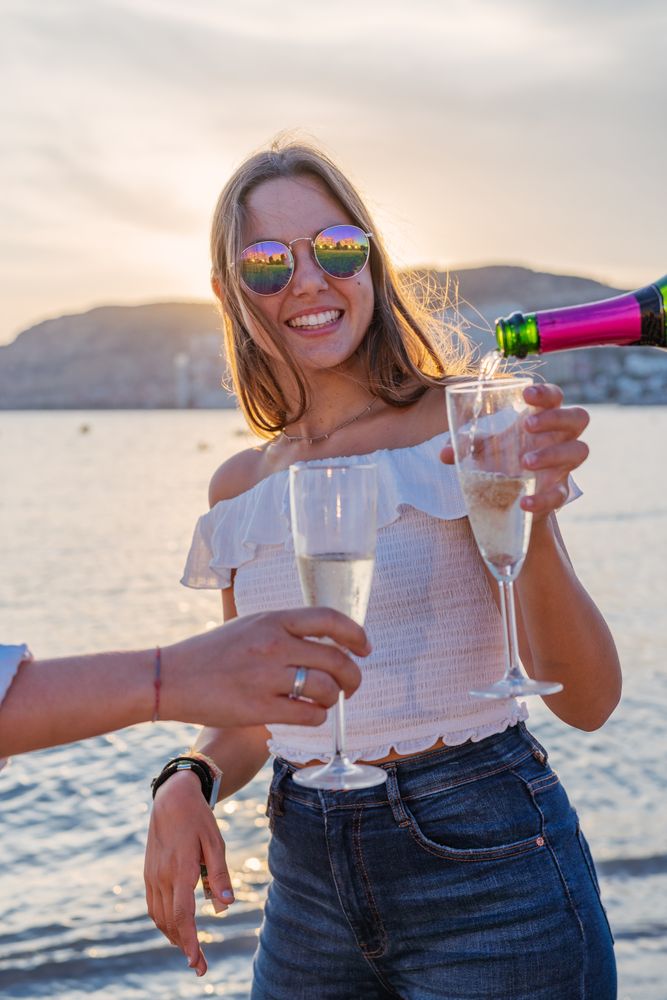 Happy family drinking wine on beach