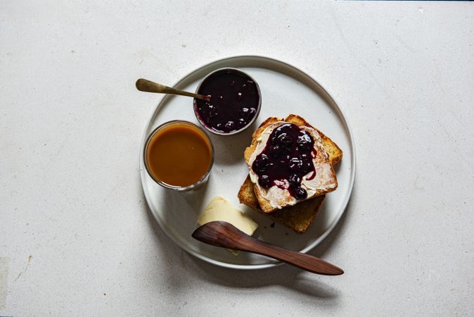 Top view of toast and blueberry jam on a plate