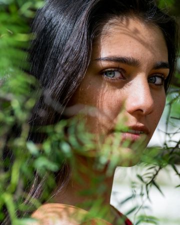 Young charming woman between flowers