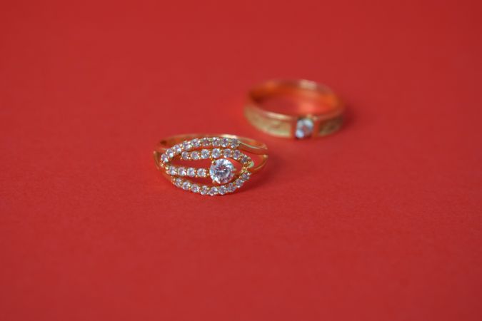 Two diamond rings on red background