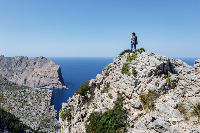 Young woman standing on cliff