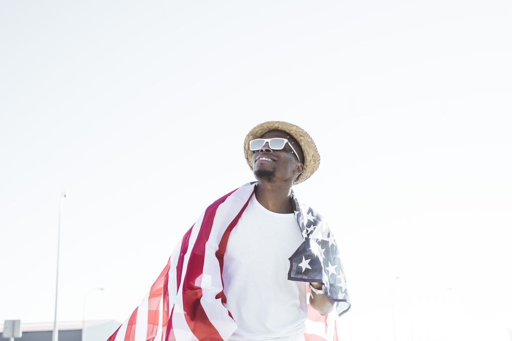 Cheerful black man with American flag