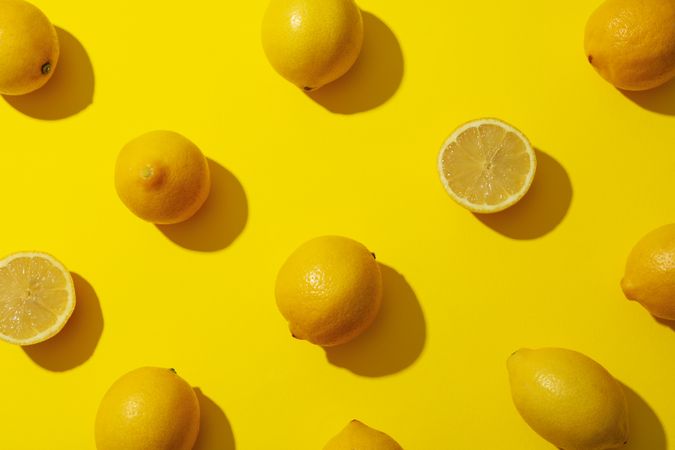 Flat lay composition with lemons on yellow background