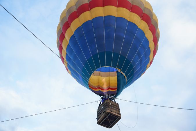 Side view of hot air balloon ascending in Aeroestacion Festival in Guadix, Granada, Andalusia, Spain