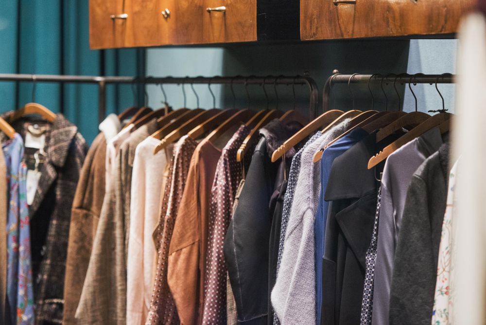 Assorted clothes hanged on rack