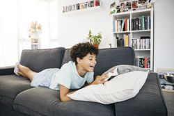 Girl reading a book on a sofa