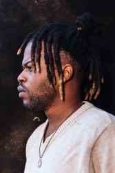 Stylish Black man with dreadlocks in buns