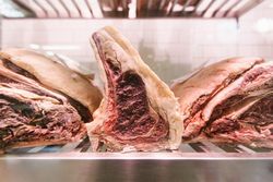 Raw meat on a butcher's chiller for maturing