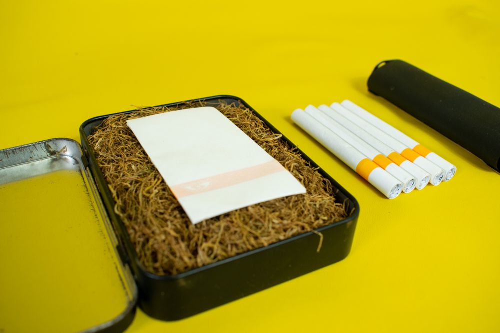 Container of loose tobacco ready for rolling