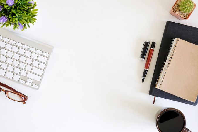 Office supplies with work space computer, pen, notepad paper, plants decorate and cup coffee