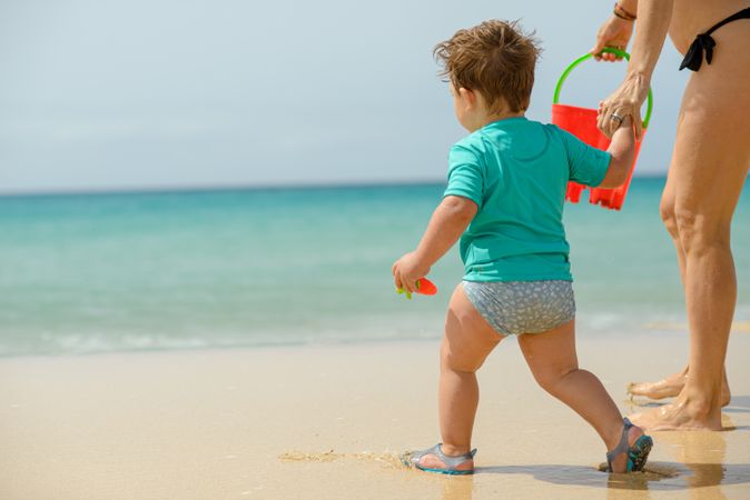 Boy playing with father on beach