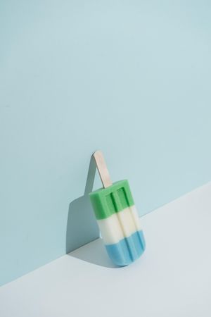 Colorful ice cream popsicle on pastel pink background