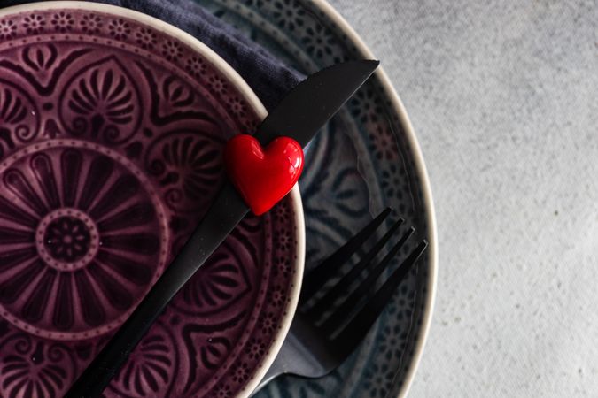 Close up of patterned plates with heart decoration