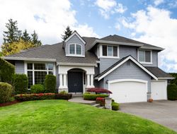 Clean home with healthy front yard during late spring