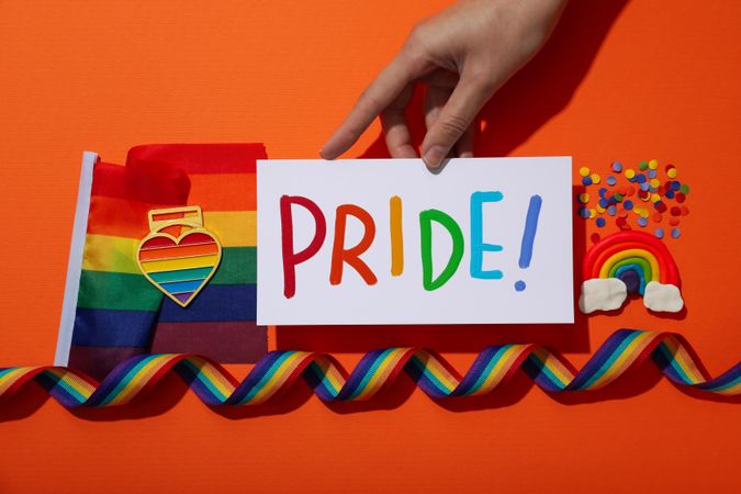 Pride parade concept, symbols on orange background.