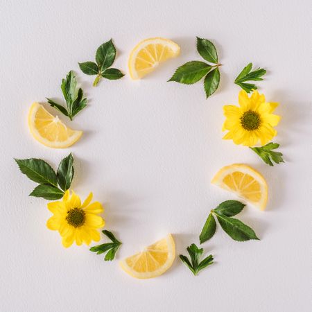 Round wreath of yellow flowers lemon slices and leave