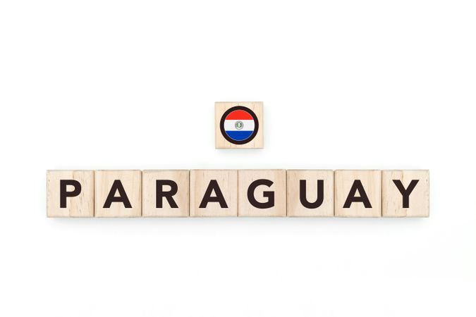 Wooden blocks bearing the name and flag of Paraguay. Paraguayan and South American Culture, national identity, travel, and geography in a copy space design.