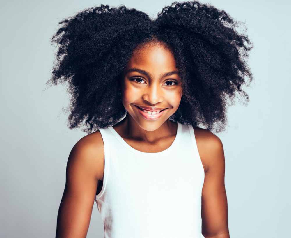 Studio portrait of smiling girl wearing simple vest