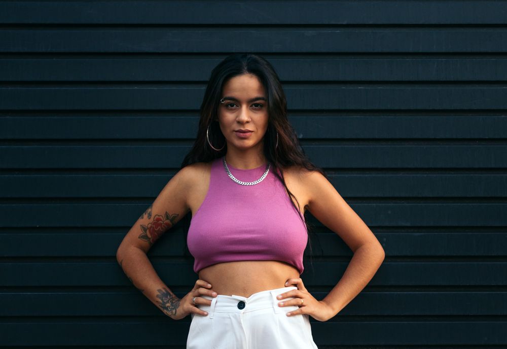 Portrait of a latina with tattoos and piercings outdoors