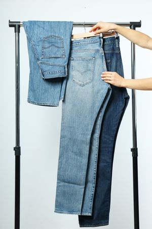 Jeans hang on hangers