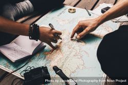 Hands of people planning trip with world map 49m6zy