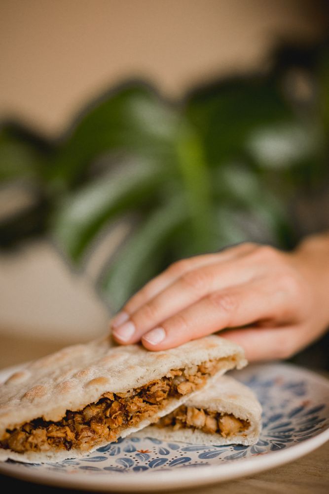 Hand holding hot delicious Chinese burgers in Asian restaurant