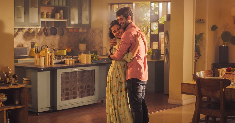 A Heartwarming Moment of Reunion: Young Couple Meet at Home and Greet Each Other with Warmth and Affection after Long Parting.