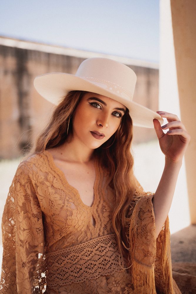 Elegant female in long dress on window