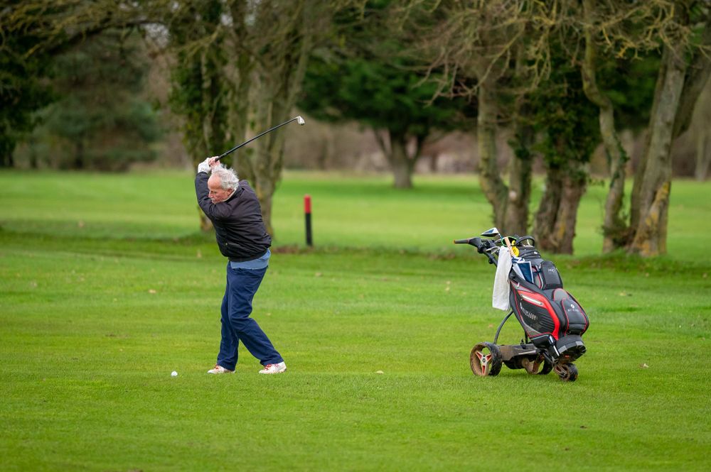 Man swinging on golf course
