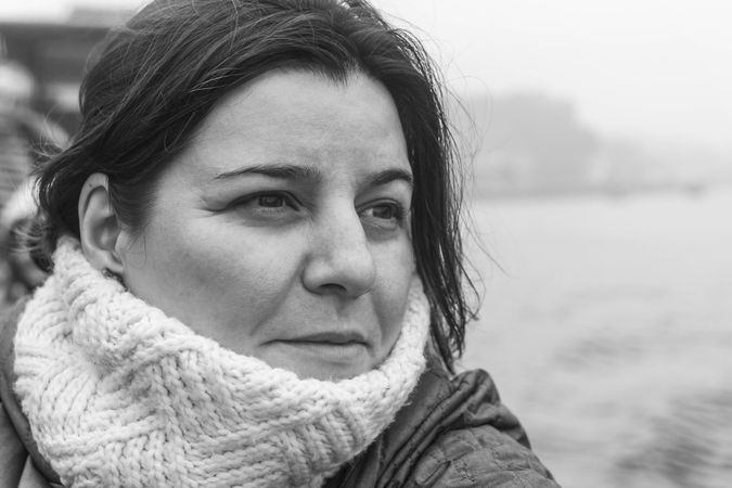 Portrait of middle aged woman wearing a scarf in grayscale
